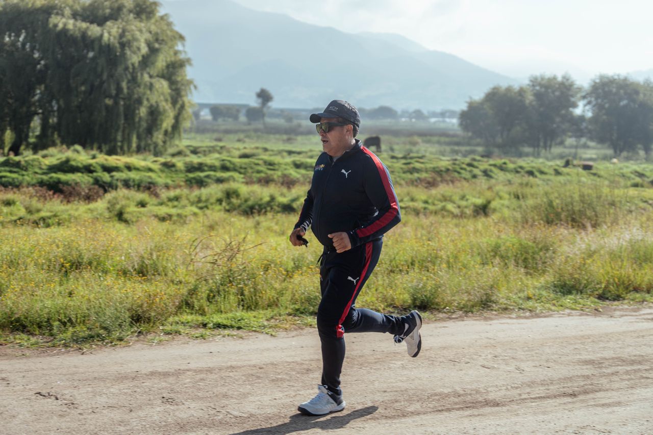 An active adult running comfortably outdoors, representing natural knee preservation and athletic joint mobility.