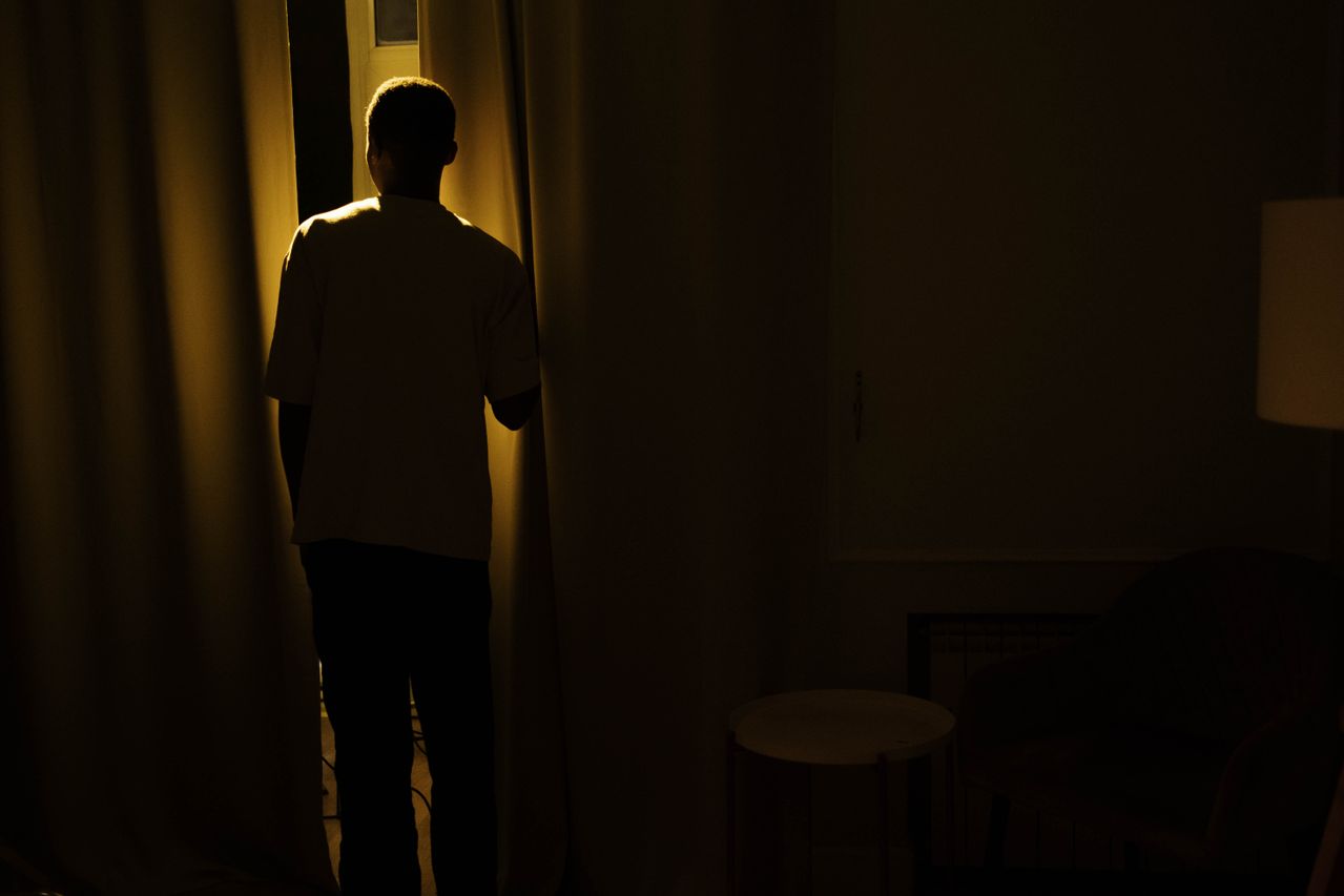 Person struggling with chronic insomnia while looking at the clock at night