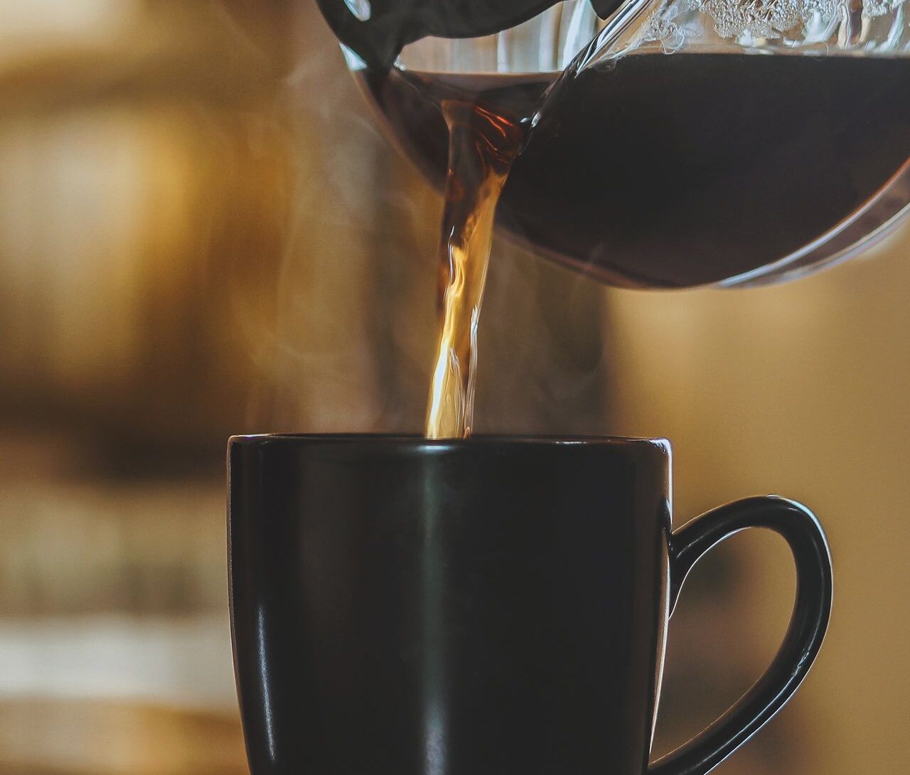 Cup of morning coffee beside a sunlit window, illustrating caffeine timing and daytime energy.