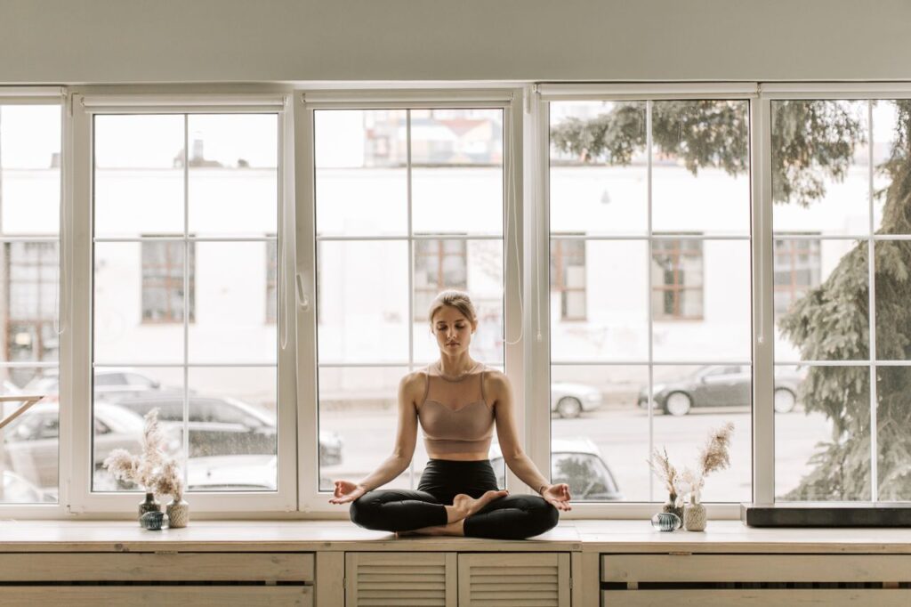Person practicing 10 minutes of mindfulness meditation in a quiet room